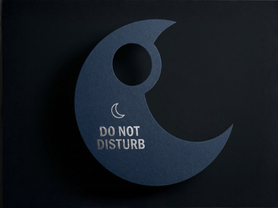 Custom crescent moon-shaped hotel door hanger in dark blue with "Do Not Disturb" text and a moon icon